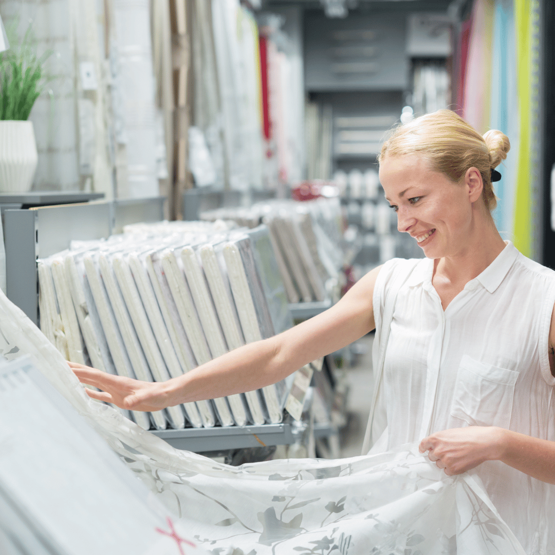 A woman choosing curtains.